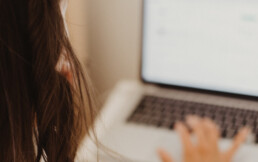 Women typing at a laptop