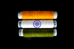 Three rolls of thread, green, white, orange, symbolising the Indian flag